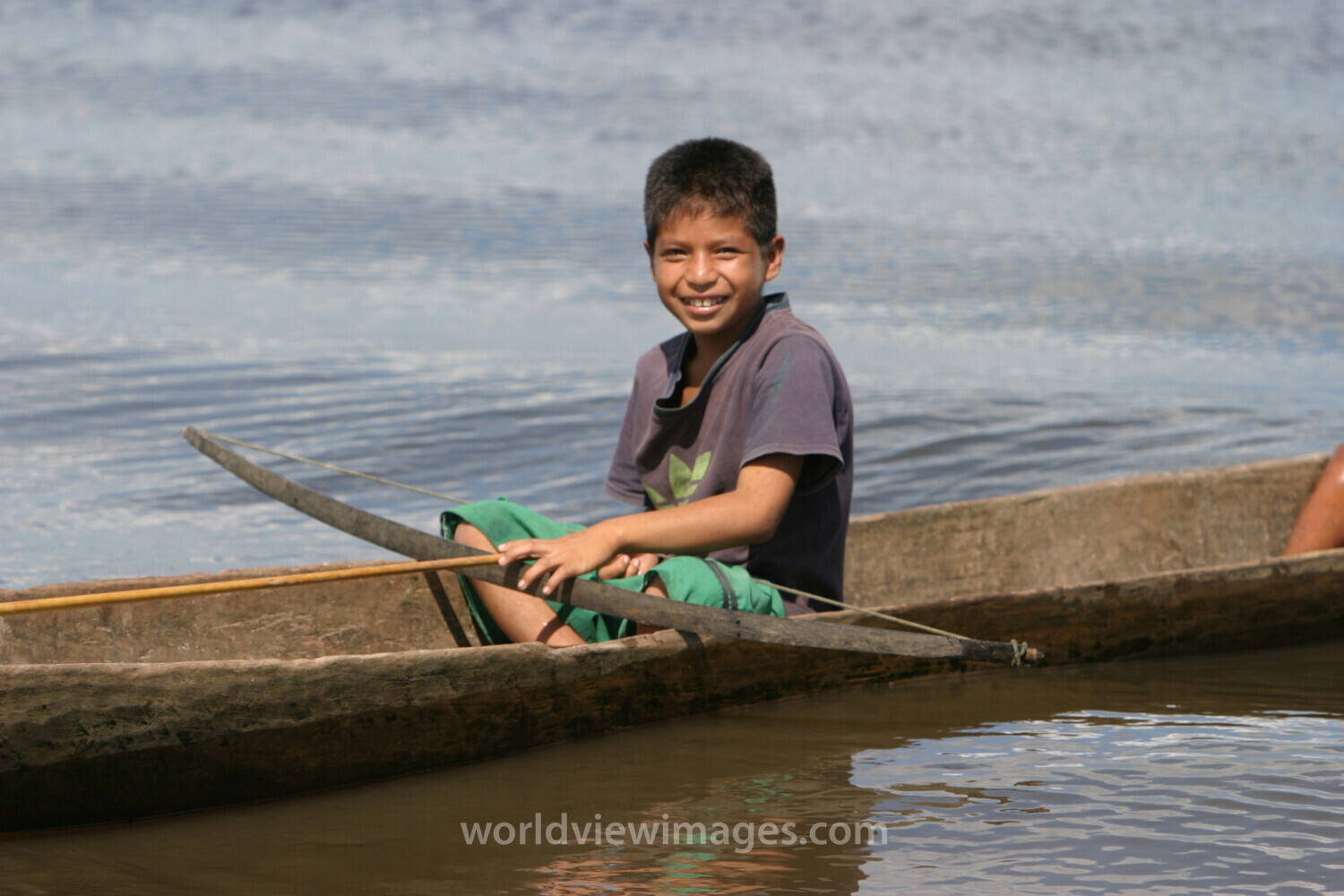 Boy in Dugout Canoe in Peru