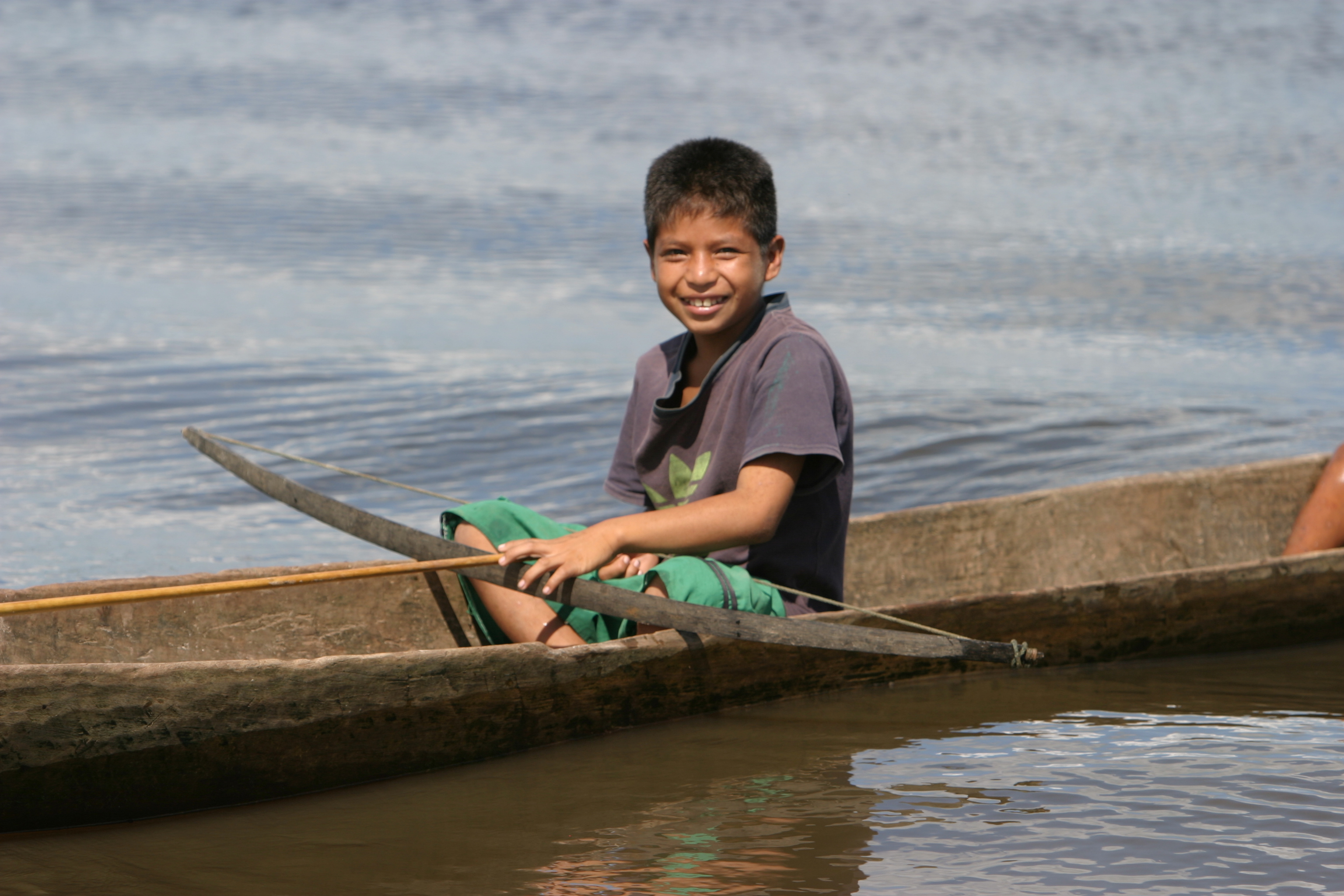Boy in Dugout Canoe in Peru