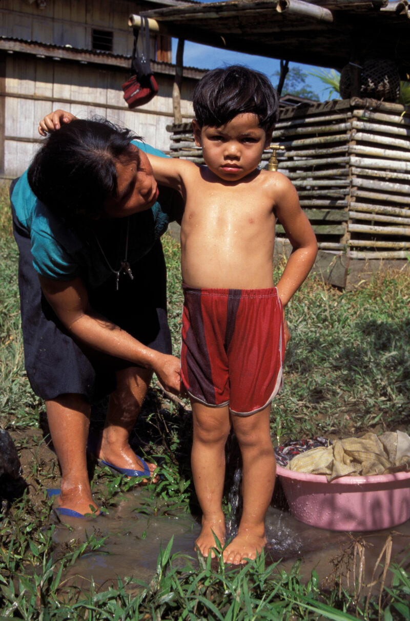 Washing Up in the Philippines — Child gets a shower at the ADRA installed water tap in the Philippines — Philippines, child, children shower, bathing, water