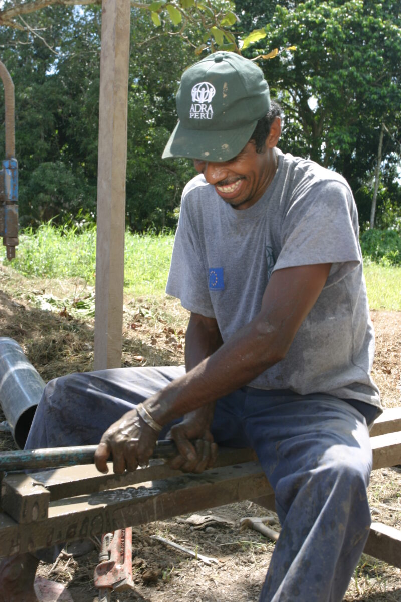 Drilling Well in Peru — Technicians from ADRA help Shipibo villagers to install a well and pump in their village in the jungles of Peru — Peru, ADRA, Poverty...