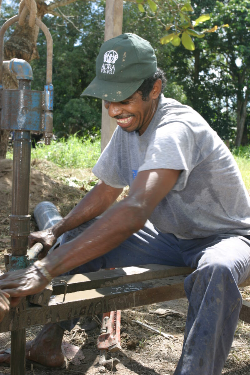 Drilling Well in Peru — Technicians from ADRA help Shipibo villagers to install a well and pump in their village in the jungles of Peru — Peru, ADRA, Poverty...
