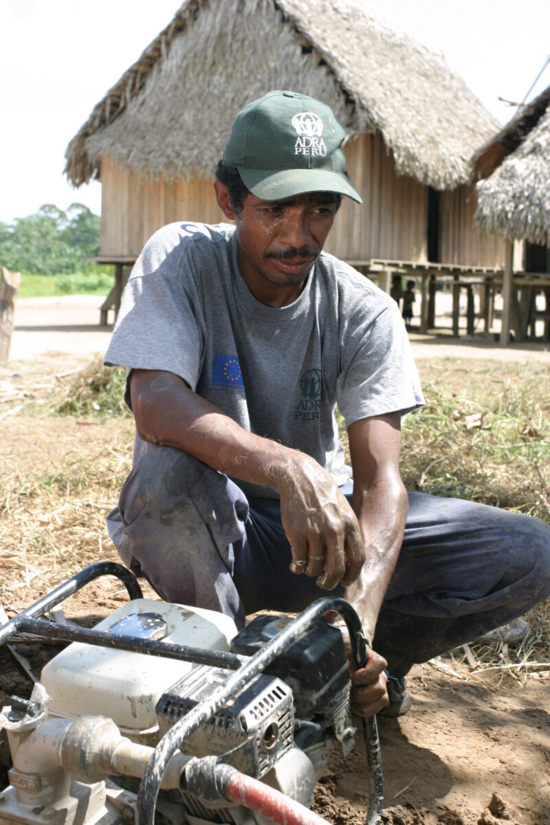 Drilling Well in Peru — Technicians from ADRA help Shipibo villagers to install a well and pump in their village in the jungles of Peru — Peru, ADRA, Poverty...