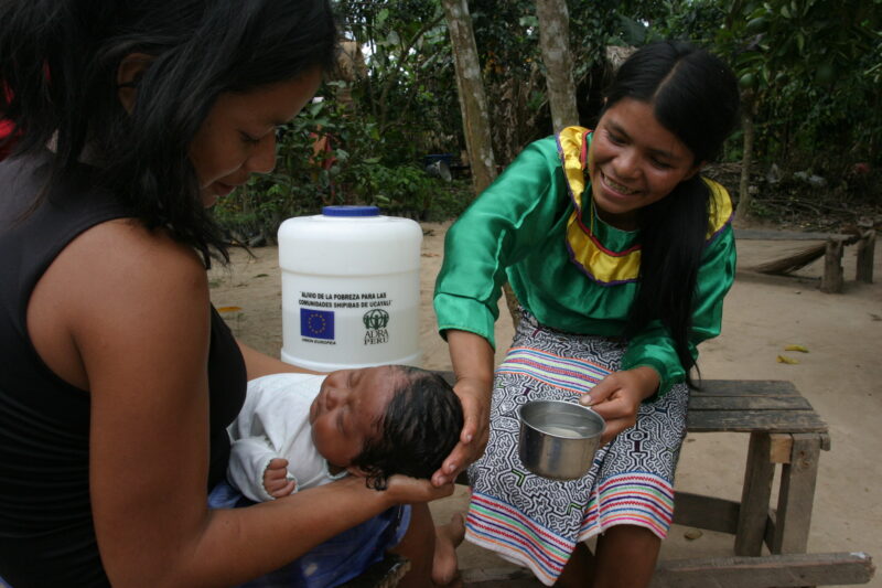 Bathing Baby in Peru — Shipibo woman washes her baby with water from the well ADRA helped install in her village. — Peru, ADRA, water, washing, baby