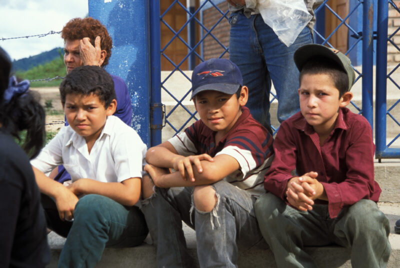 Internally Displaced in Honduras — Children from a village in Honduras that was wiped out by mudslides sit in front of their new homes build by ADRA — Hondur...