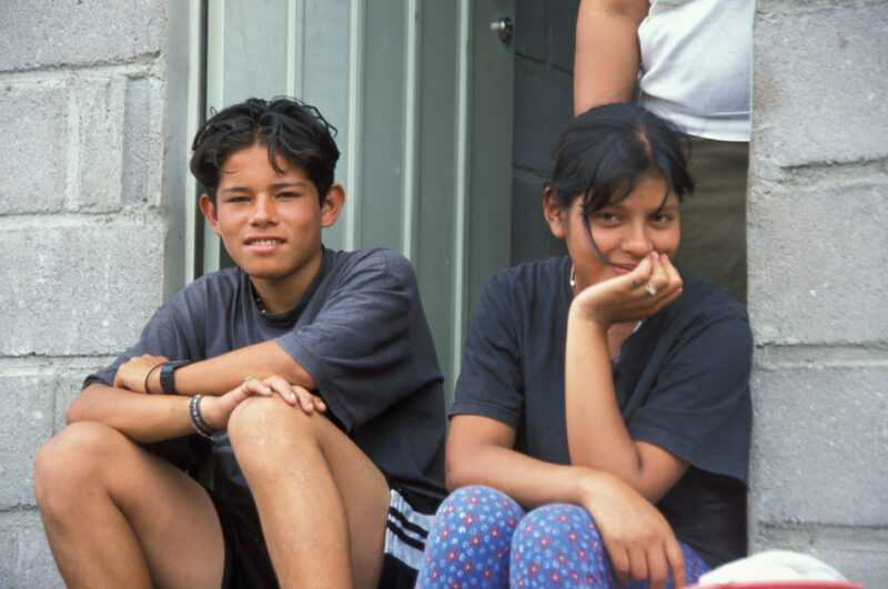 Internally Displaced in Honduras — Children from a village in Honduras that was wiped out by mudslides sit in front of their new homes build by ADRA — Hondur...