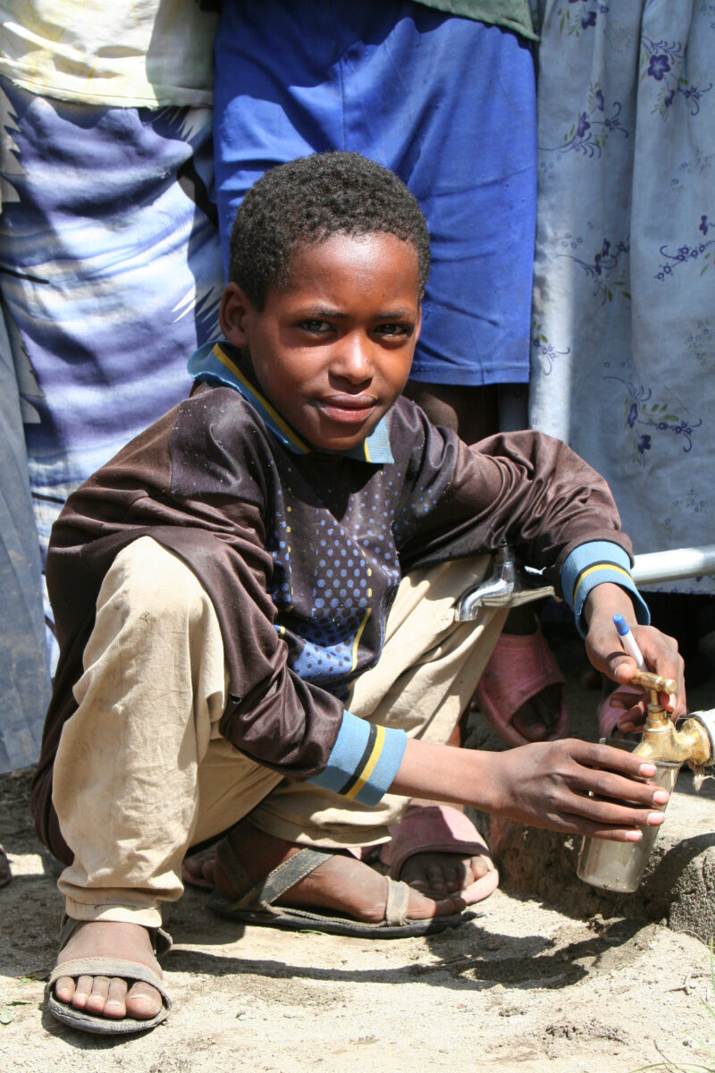 Boy Gets Drink at School — Students enjoy the convenience of water from a tap, outside their new school provided by ADRA Norway — Ethiopia, Africa, African, ...