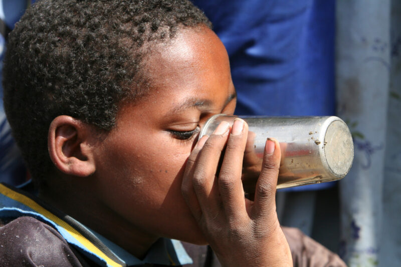 Boy Gets Drink at School — Students enjoy the convenience of water from a tap, outside their new school provided by ADRA Norway — Ethiopia, Africa, African, ...