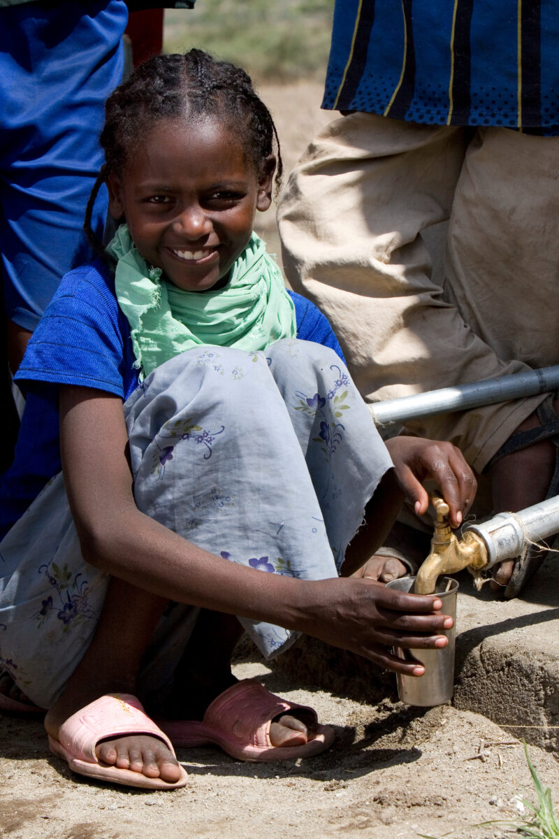 Girl Gets Drink at School — Students enjoy the convenience of water from a tap, outside their new school provided by ADRA Norway — Ethiopia, Africa, African,...