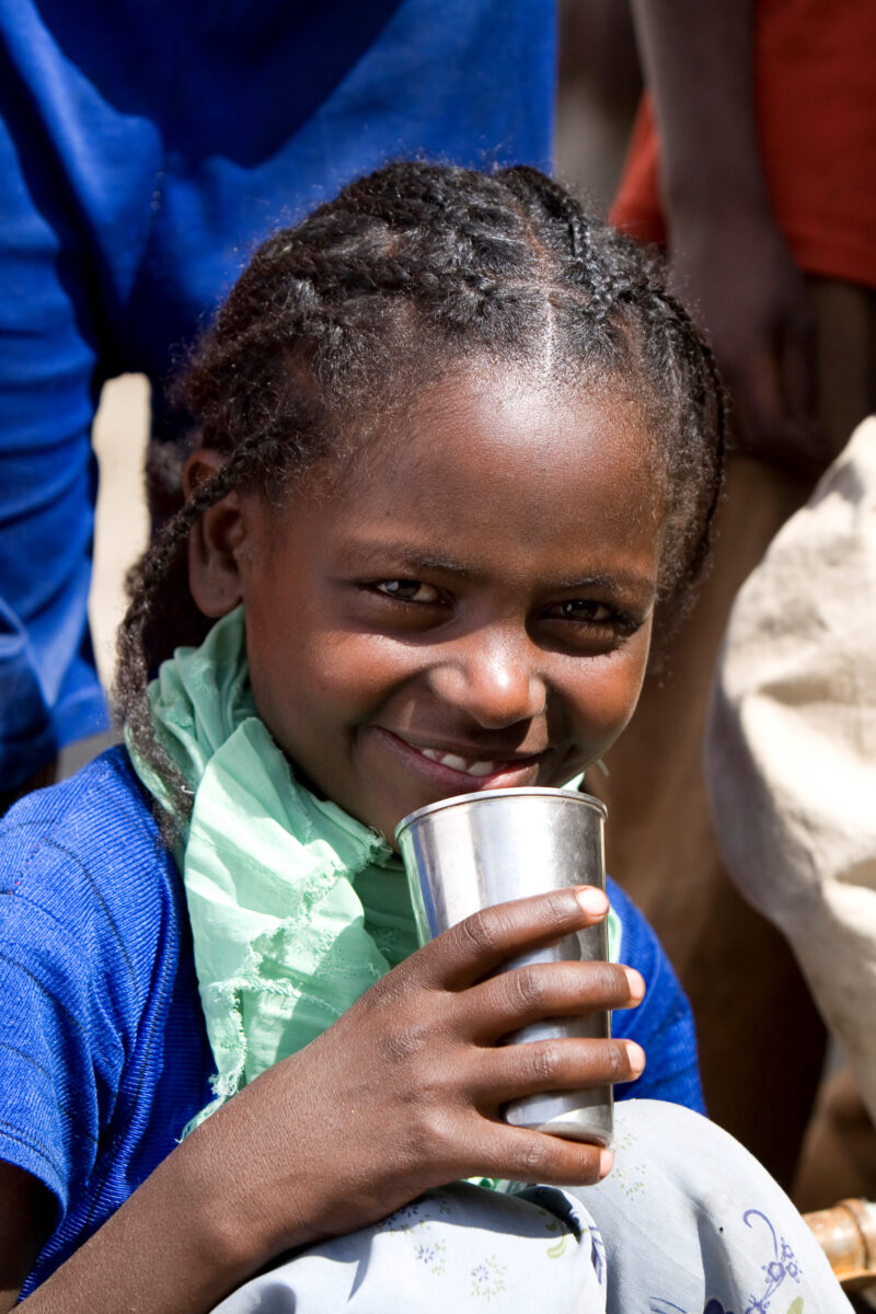 Girl Gets Drink at School — Students enjoy the convenience of water from a tap, outside their new school provided by ADRA Norway — Ethiopia, Africa, African,...