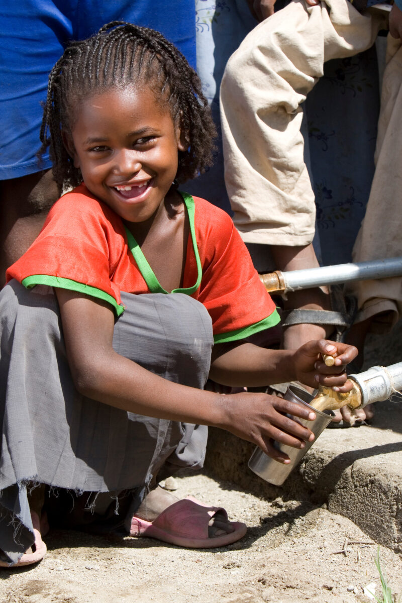 Girl Gets Drink at School — Students enjoy the convenience of water from a tap, outside their new school provided by ADRA Norway — Ethiopia, Africa, African,...