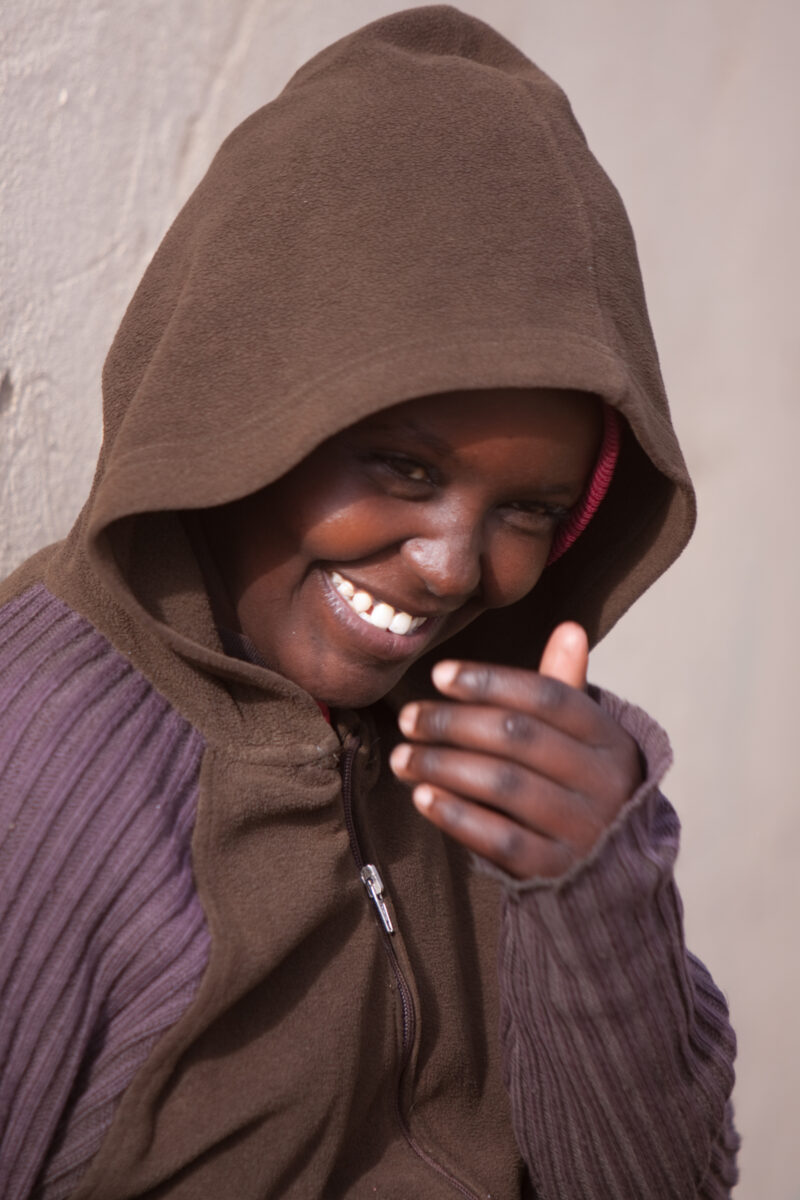Girl in Kenya — Girl laughs outside her boarding school in Kenya — Africa, Kenya, children, faces, girls
