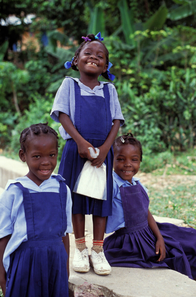 Stock Images of Haiti — School girls in Haiti along a roadside, smile for camera — Haiti, Caribbean, Poverty, girl, girls
