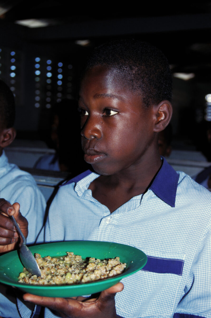 Stock Images of Haiti — Stock Image of Haiti: Student has a hot lunch at school in Haiti — Haiti, Haitian, boy, boys, student