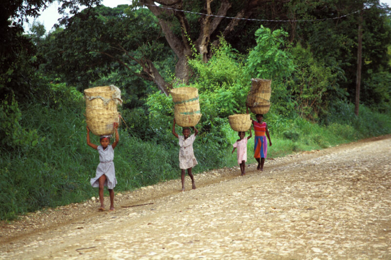 Stock Images of Haiti — Stock Image of Haiti: Children walk down road with baskets on head. — Haiti, Haitian, road, roads, children