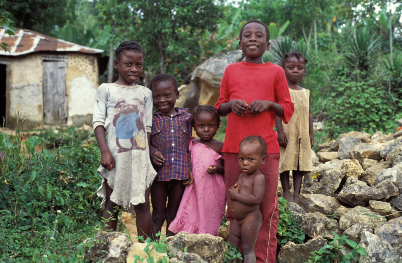 Stock Images of Haiti — Stock Image of Haiti: Poor children in rural haiti stand beside their home. — Haiti, Haitian, children, poor, poverty