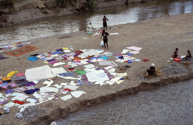 Stock Images of Haiti — Stock Image of Haiti: Laundry dries in the sun on a sand bar in a river in Haiti — Haiti, Haitian, river, laundry