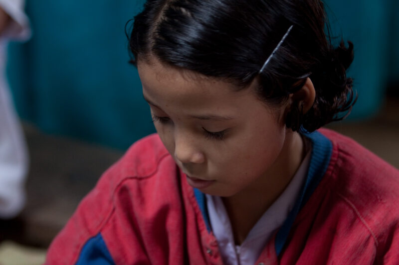 Student in a Refugee Camp — Karen people from Myanmar (Burma) have spent years in in refugee camps along the Thai/Burma border, to avoid violence from the mi...