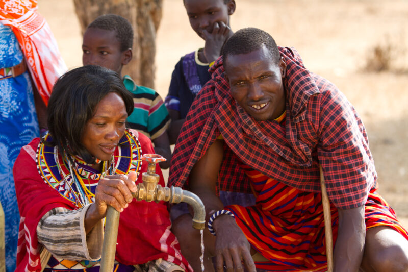 Collecting Water — Maasai collect water from a borehole tap in a dry region of Kenya Africa — Kenya, Water, collecting water, Africa, Maasai