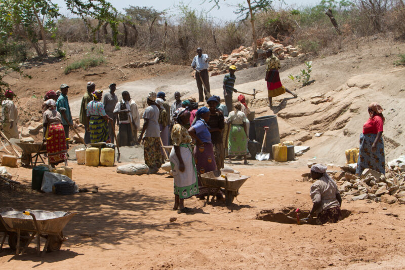 Building a Dam in Kenya — Villagers work together in a "food for work" program to build a small dam on the seasonal river that runs by their village. — Kenya...