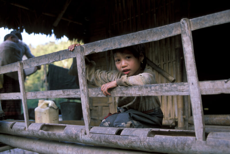 Girl in Laos — Ethnic minority girl smiles from her home in northern Laos. — Laos, Southeast Asia, girl, girls, ethnic minorities