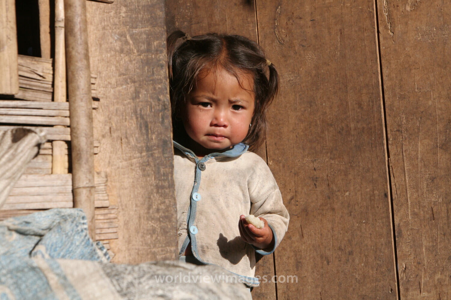 Baby in Doorway in Laos