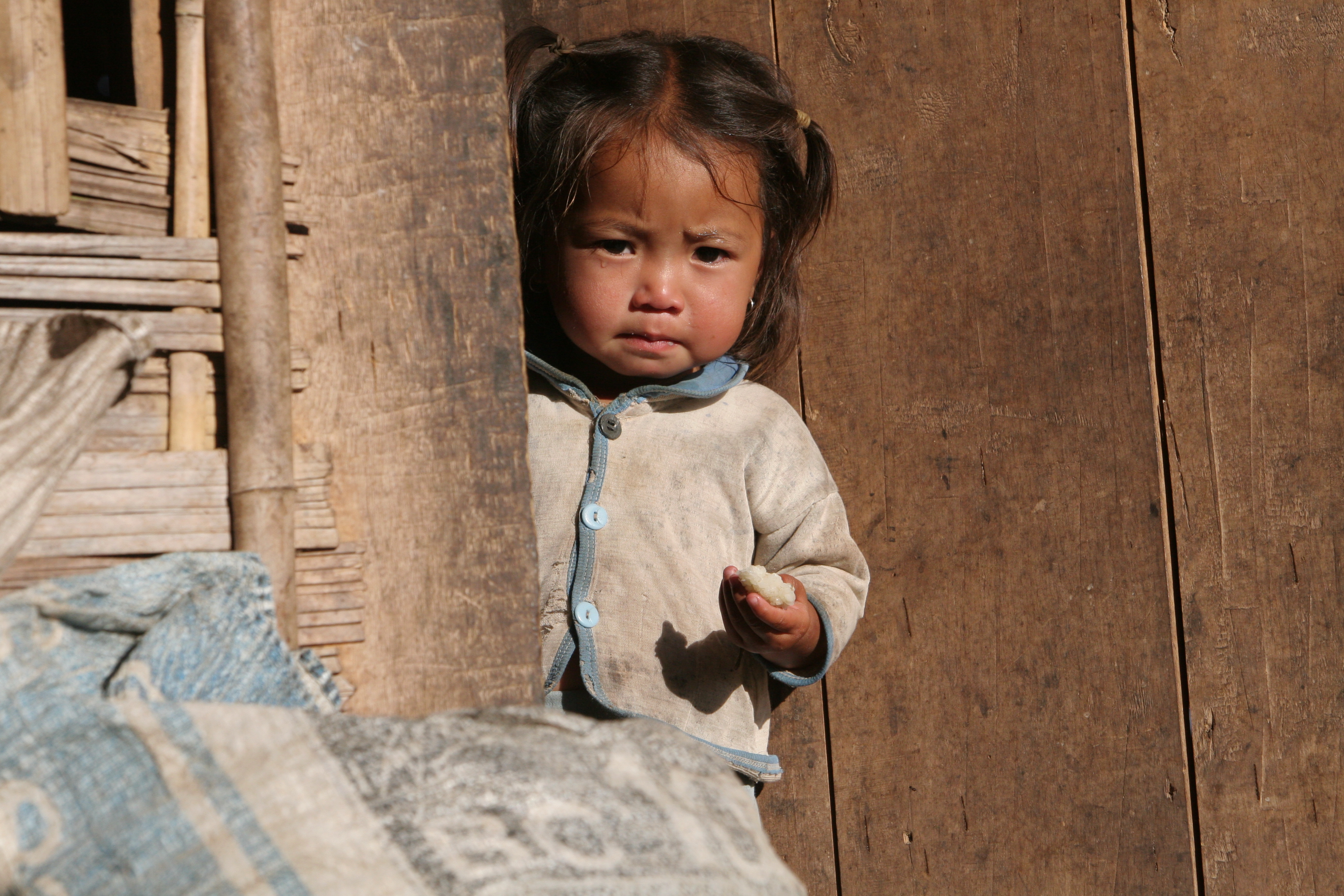 Baby in Doorway in Laos