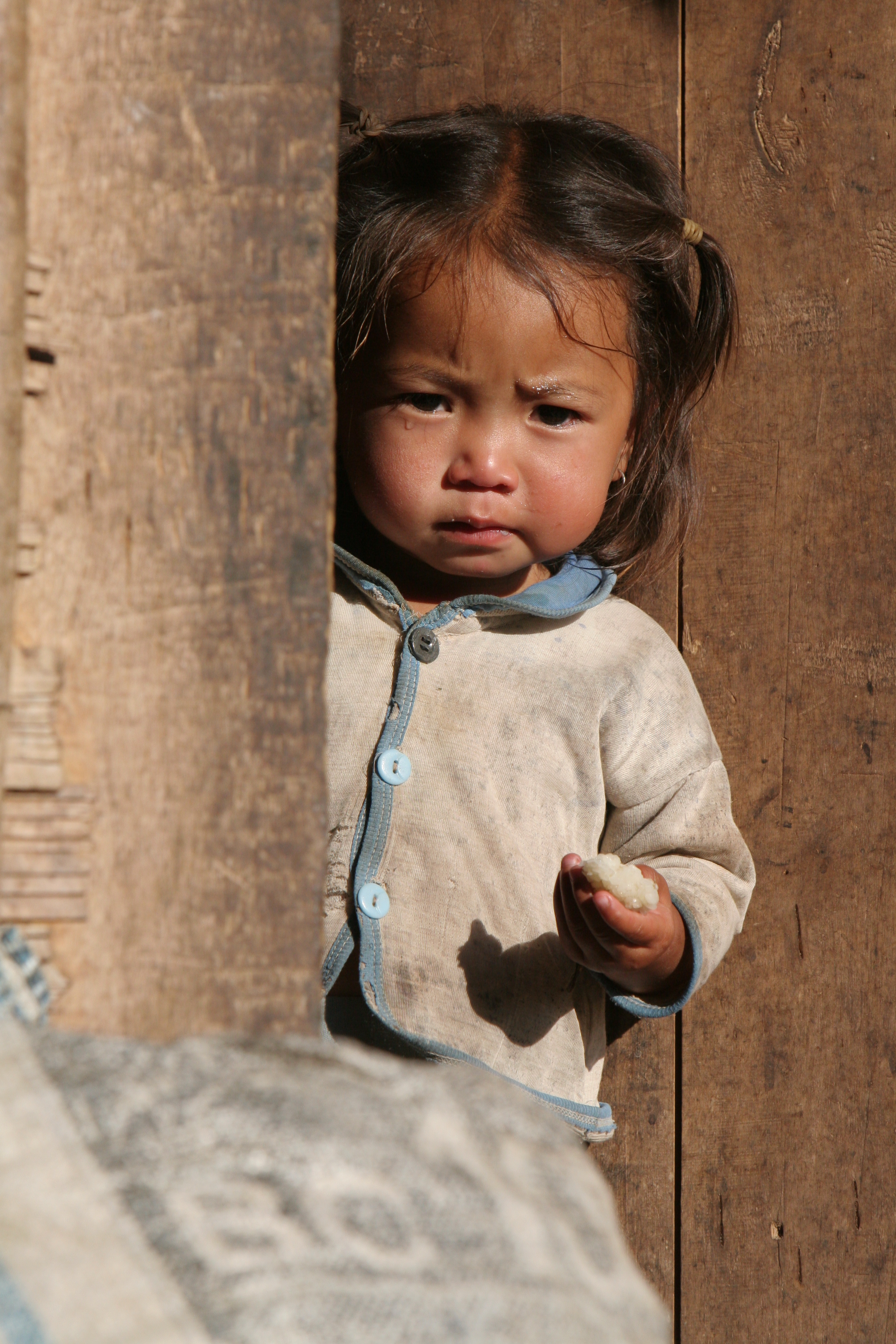 Baby in Doorway in Laos