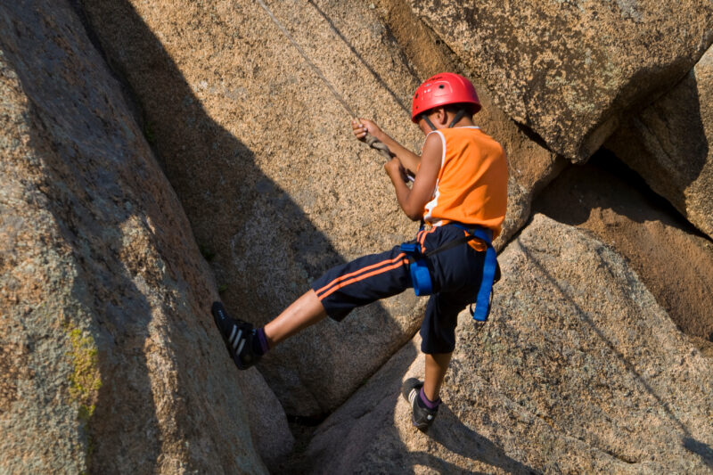 Repelling in Mongolia — Boy attending a youth camp in Mongolia repels down a rock cliff — Mongolia, Youth, ADRA, youth Camp, boy