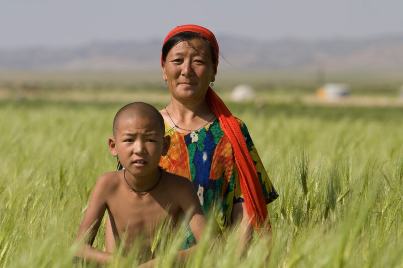 Mother and Son in Mongolia — Stock Image woman and her son in Mongolia in the wheatfield that they have learned to grow, from an ADRA Agricultural training p...
