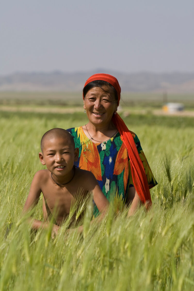 Mother and Son in Mongolia — Stock Image woman and her son in Mongolia in the wheatfield that they have learned to grow, from an ADRA Agricultural training p...