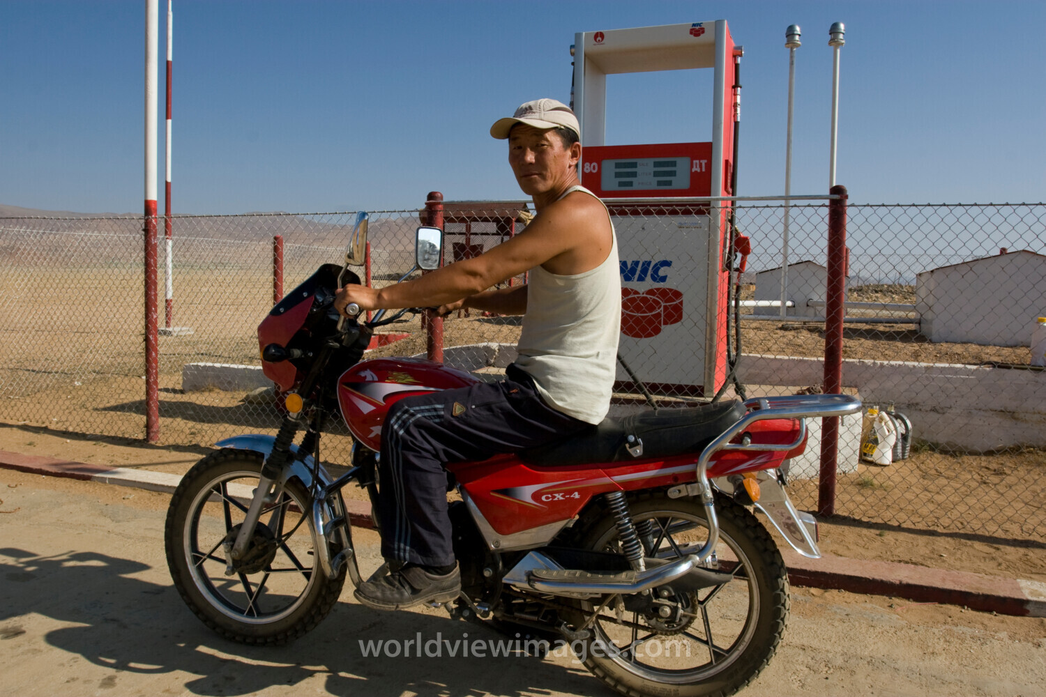 Man on Motorbike at gas station in Mongolia