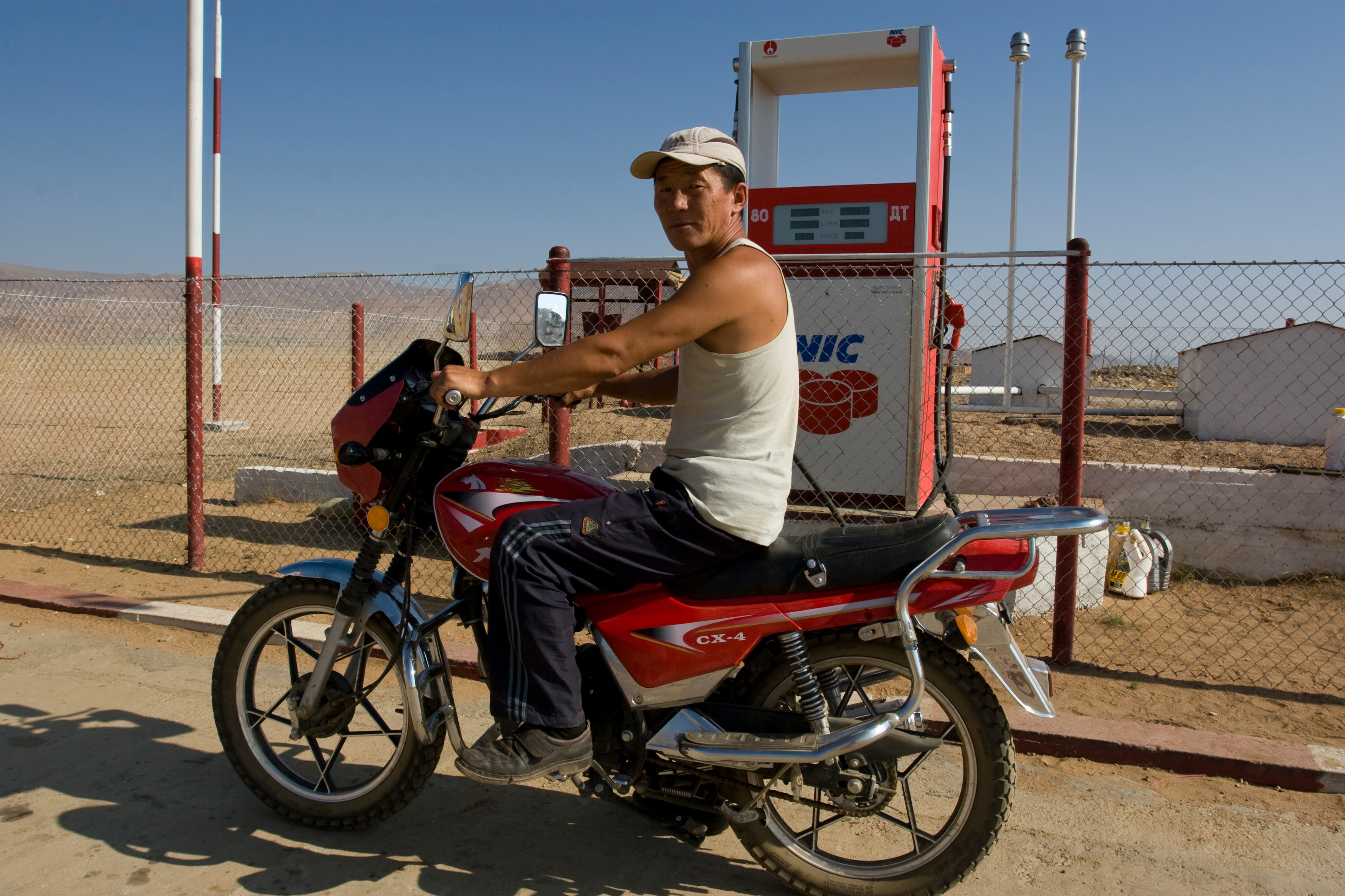 Man on Motorbike at gas station in Mongolia