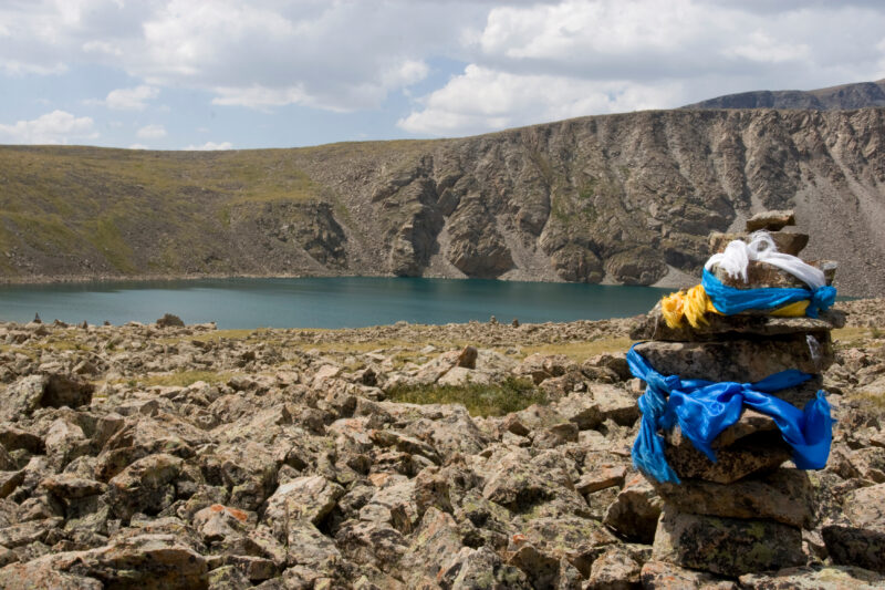 Mongolian Cerimonial Cairn — Typical sight on the tops of hills or important crossroads in the steppes of Mongolia is a cairn that people cover with a blue c...