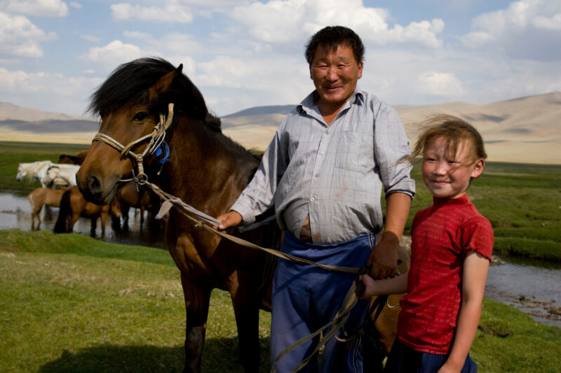 Father and Daughter in Mongolia — Man stands with his horse and daughter on the steppes of Mongolia — Mongolia, man, men, girl, horse