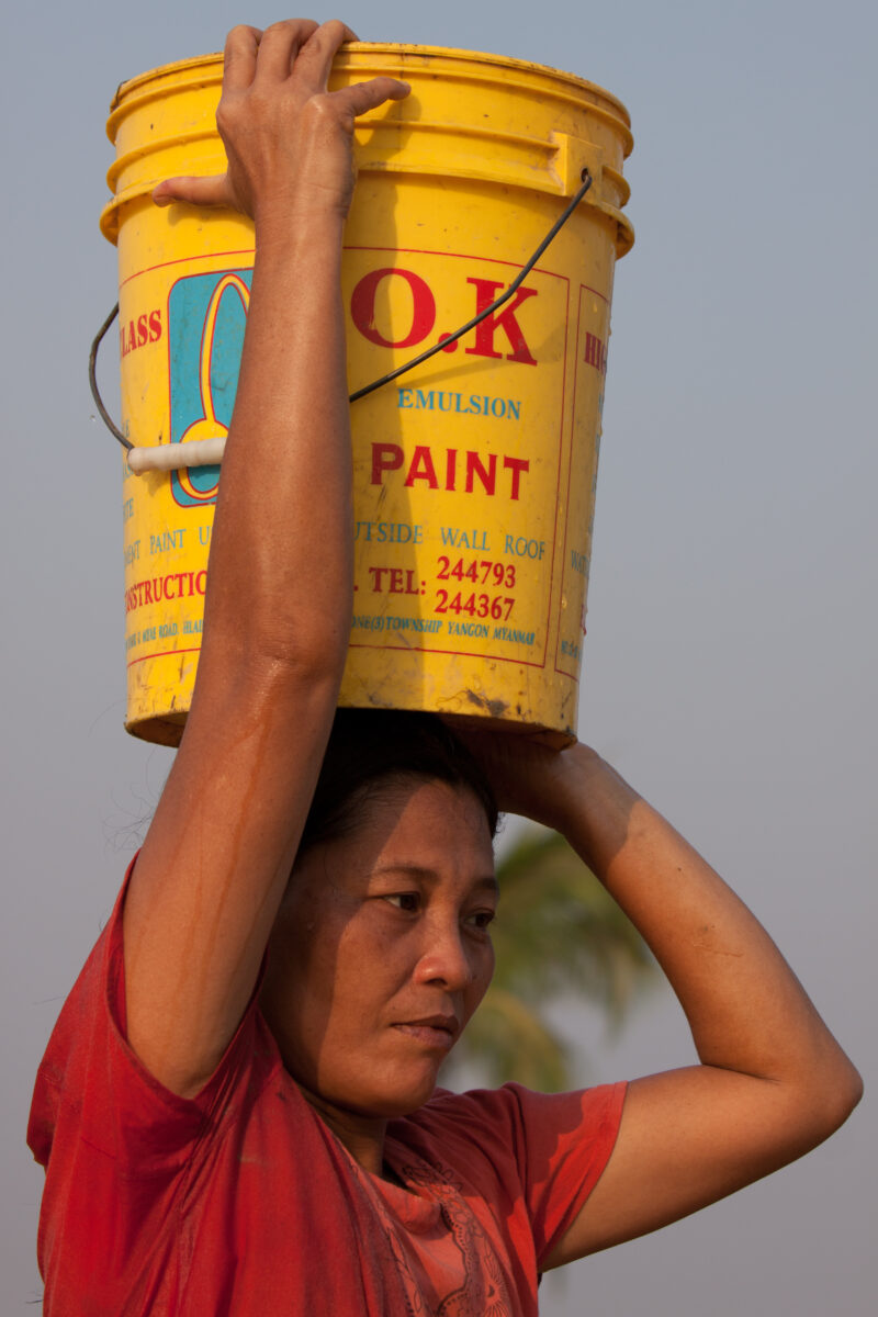 Woman Collects Water in Burma — Stock Images of life in the Irrawaddy Delta region of Burma, after cyclone Nargis devistated the region: Collecting safe Wate...