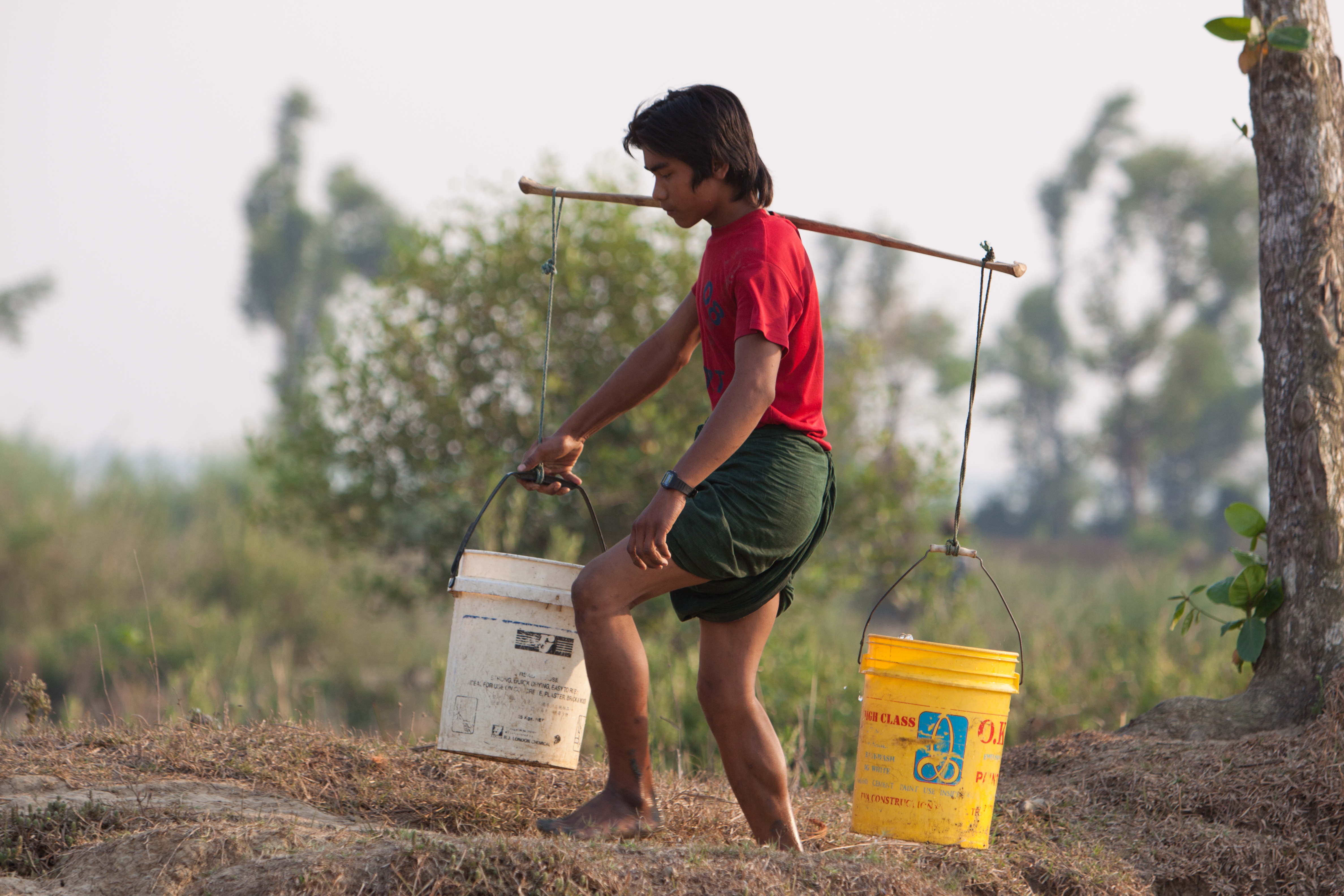 Boy Collects Water in Burma