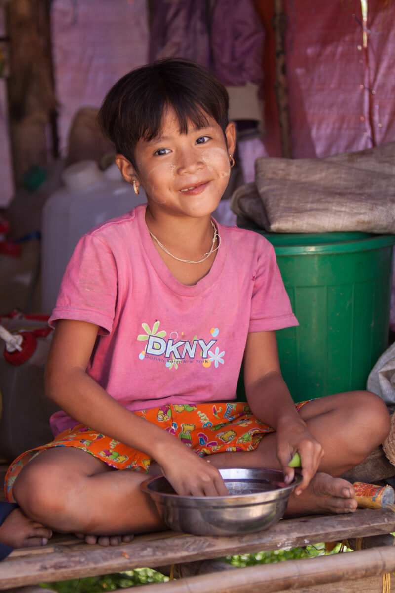 Girl Eats Rations in Burma — Girl eats rice from a emergency food distribution of ADRA in the Irrawaddy Delta region of Myanmar, after Cyclone Nargis destroy...