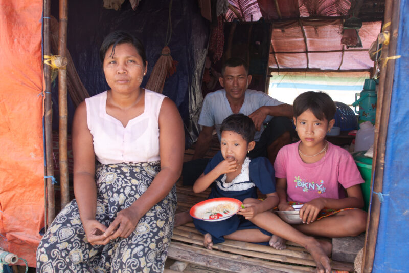 Family in Shelter after Cyclone — Girl eats rice from a emergency food distribution of ADRA in the Irrawaddy Delta region of Myanmar, after Cyclone Nargis de...