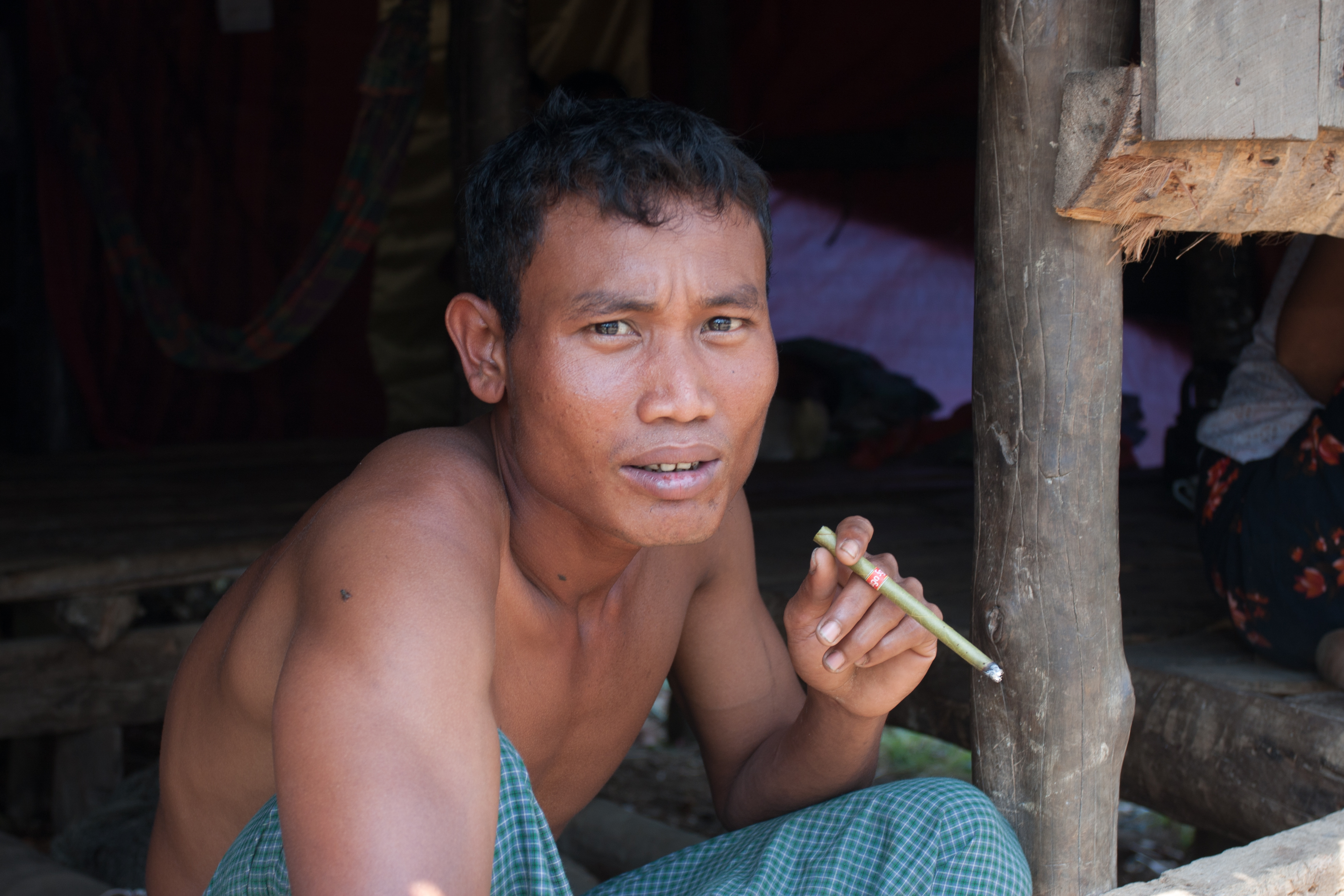 Man Smokes Cigar in Burma