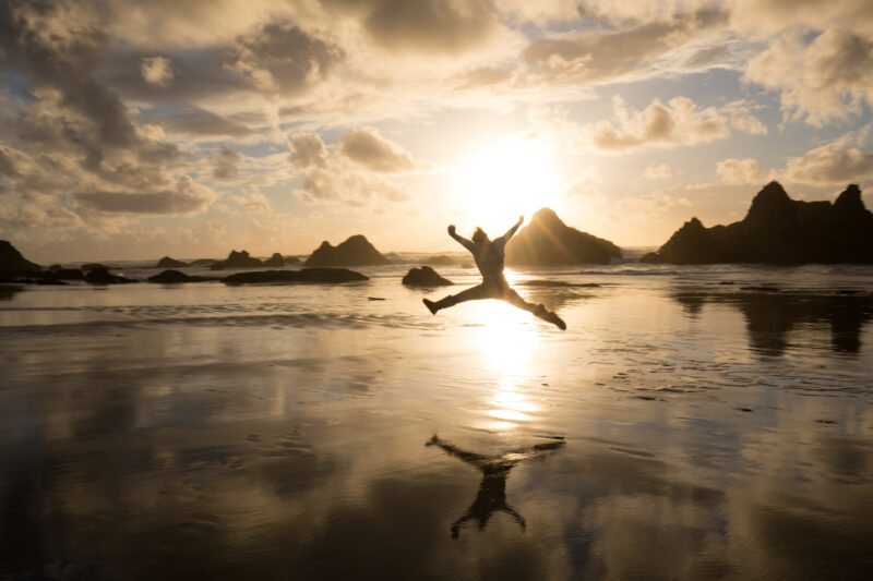 Pure Joy — Woman expreses her joy at a beautiful sunset on the Oregon Coast in the United States — Beach, Coast, Ocean, Oregon, Sea