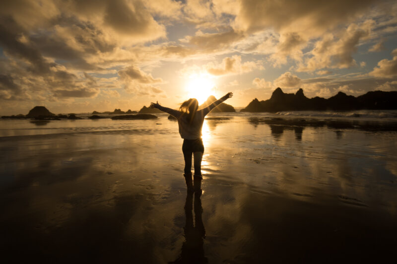 Pure Joy — Woman expreses her joy at a beautiful sunset on the Oregon Coast in the United States — Beach, Coast, Ocean, Oregon, Sea