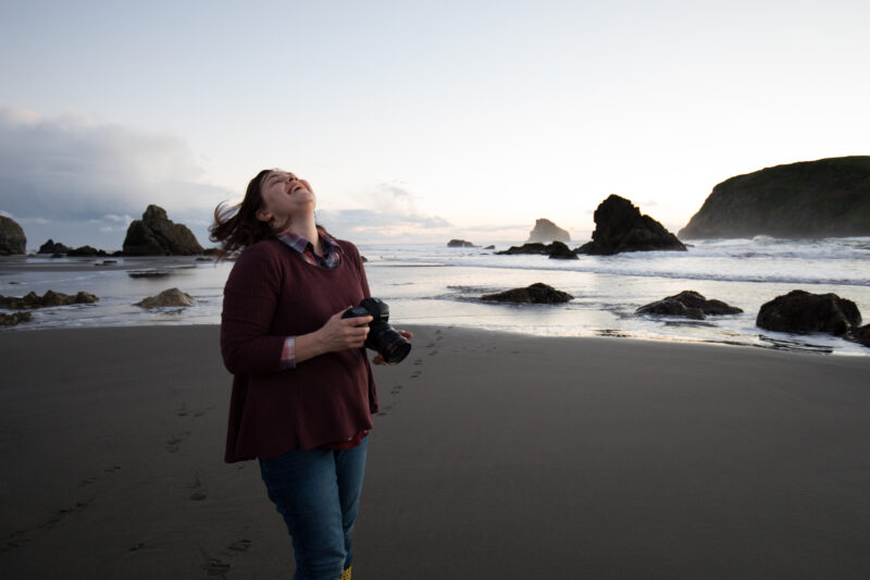 Happiness and Joy! — Woman laughs while photgraphing a beautiful scene on the oregon coast. — Beach, Coast, Ocean, Oregon, Sea