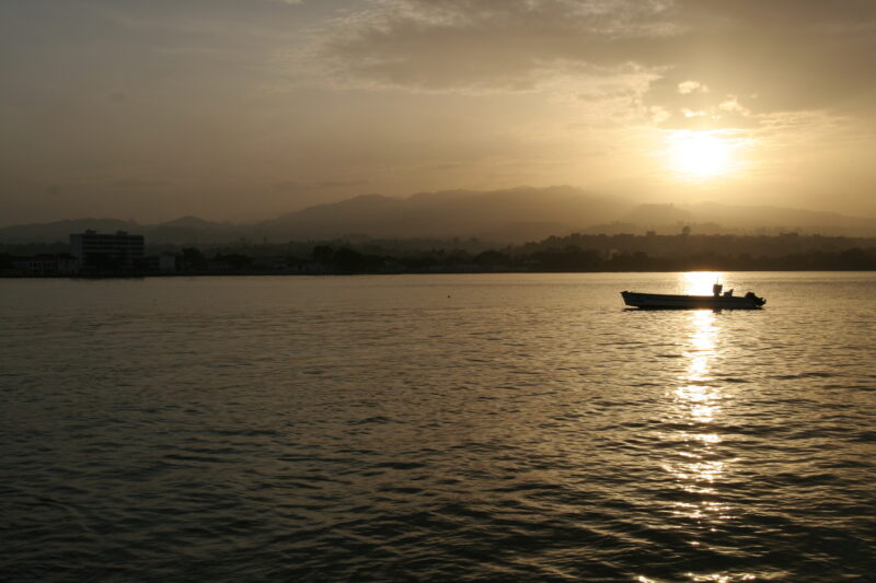 Sunset in Sao Tome — A boat in the harbor of the Capital of Sao Tome, — Sao Tome, Africa, Poverty, sunset, sunsets