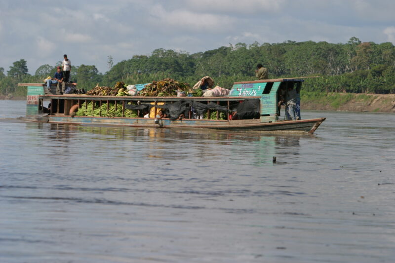 River Transport in Peru — A Banana boat makes its way to market in Pucallpa on the Ucayali river in the jungles of Peru — Peru, ADRA, Poverty, Development, P...