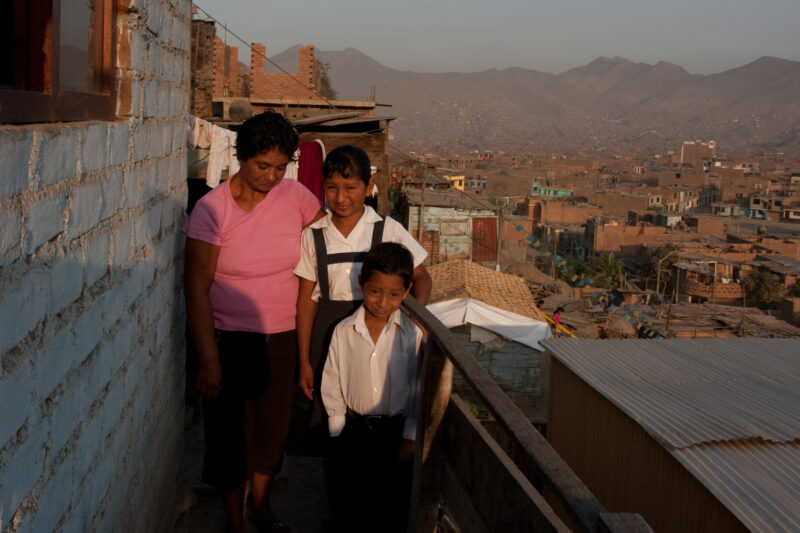 Living in Shantitown. — Profile of a mother and her two children living in one of the poor communities on the outskirts of Lima, Peru — Peru, slums, slum, sh...