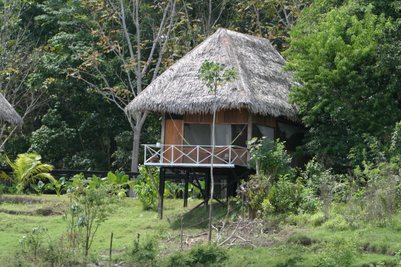 Village Housing — Simple house made of Bamboo and leaves provide shelter from the sun and rain in a village along the Ucayali River — ADRA, Peru, Poverty, Sh...