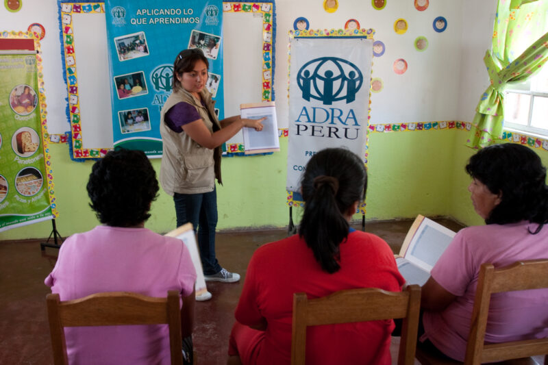Health Instruction — Women living in a poor community on the outskirts of Lima, attend a weekly workshop for instruction in an ADRA program that brings Adult...