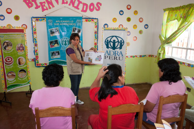 Health Instruction — Women living in a poor community on the outskirts of Lima, attend a weekly workshop for instruction in an ADRA program that brings Adult...