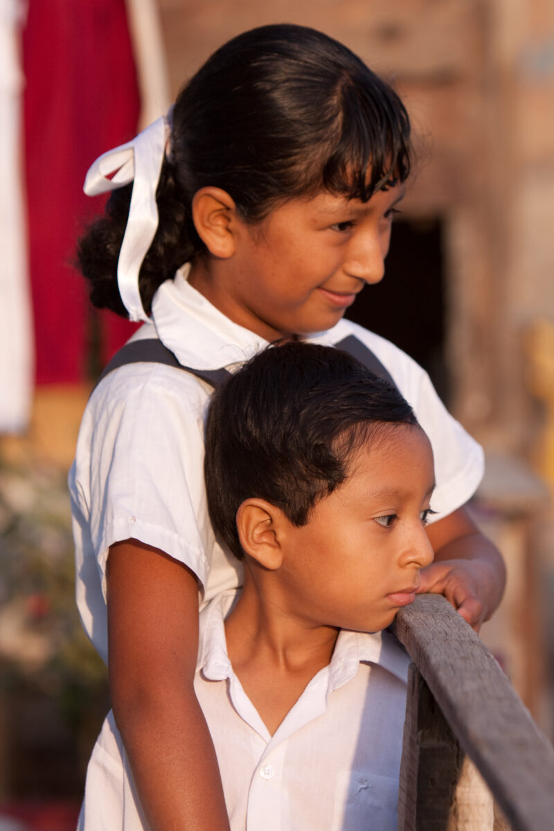 Living in Poverty — Profile of a mother and her two children living in one of the poor communities on the outskirts of Lima, Peru: Young girl and her brother...