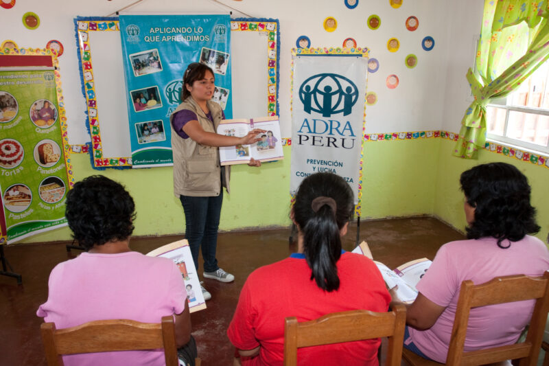 Health Instruction — Women living in a poor community on the outskirts of Lima, attend a weekly workshop for instruction in an ADRA program that brings Adult...